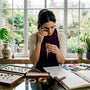 Jewelry designer inspecting ethical necklace in studio