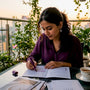 Woman researching ethical jewelry at kitchen table