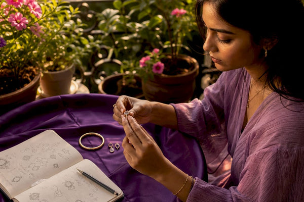 Woman inspecting sustainable jewelry at home