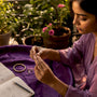 Woman inspecting sustainable jewelry at home