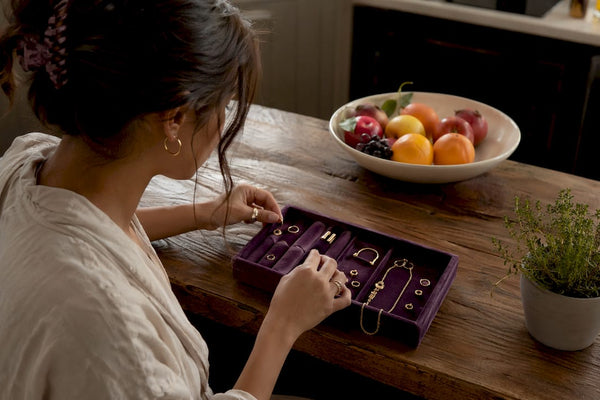 Woman selecting everyday jewelry at vanity