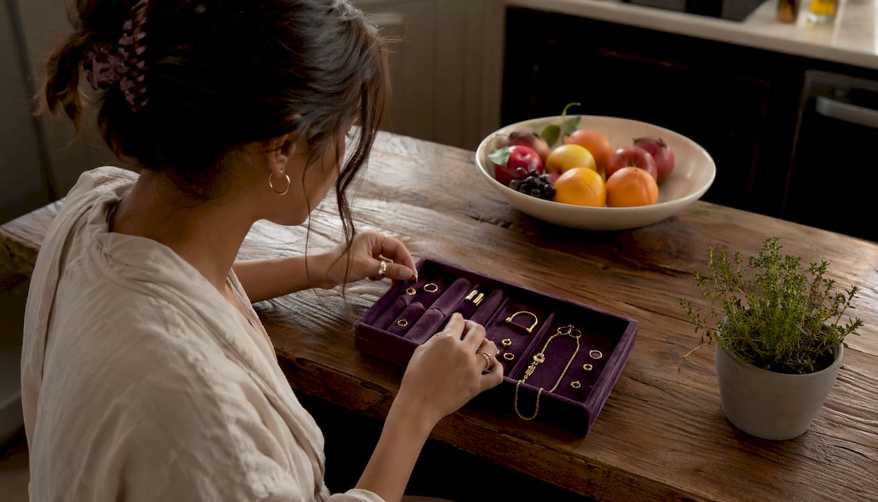 Woman selecting everyday jewelry at vanity