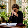 Woman appraising gold necklace at desk