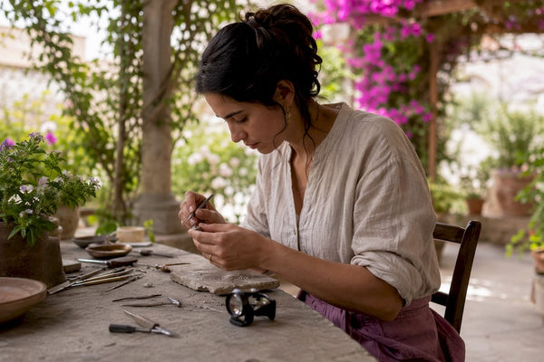 Artisan crafting fair trade jewelry by hand