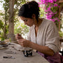 Artisan crafting fair trade jewelry by hand