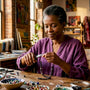 Woman crafting silver necklace in workshop