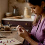Artisan inspecting handmade slow fashion jewelry