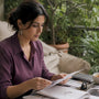 Woman reviewing ethical moissanite jewelry documents