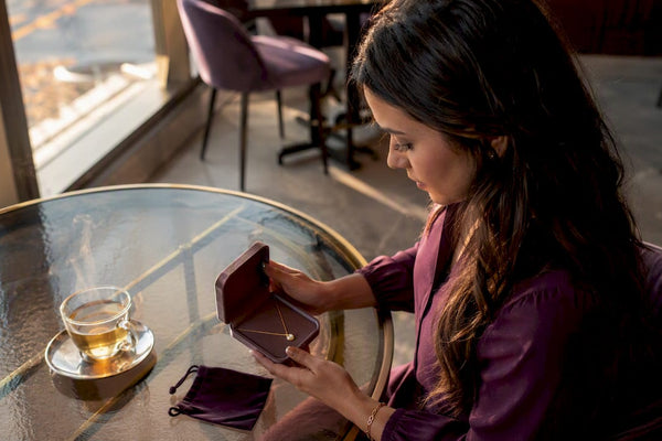 Woman preparing milestone jewelry gift at home