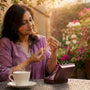 Woman holding heirloom necklace at home