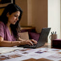 Woman negotiating jewelry prices online at home