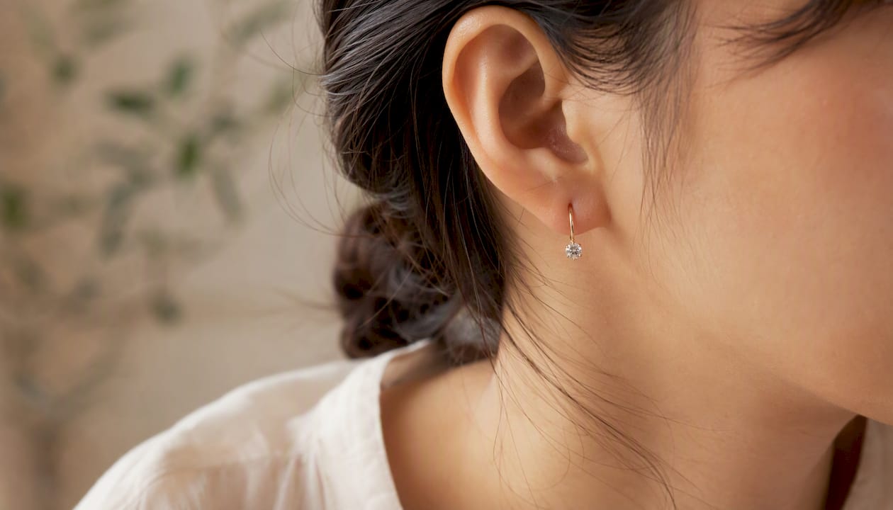Close-up of earring on sensitive skin