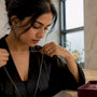 Woman measuring necklace length with string