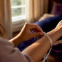 Close-up of wrist being measured for bracelet size