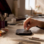 Hand placing moissanite ring on display pad