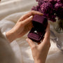 Hands opening moissanite ring box