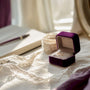 Velvet ring box with gemstone and budgeting tools