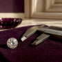 Loose moissanite beside precision measuring calipers