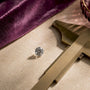 Moissanite gemstone beside millimeter gauge