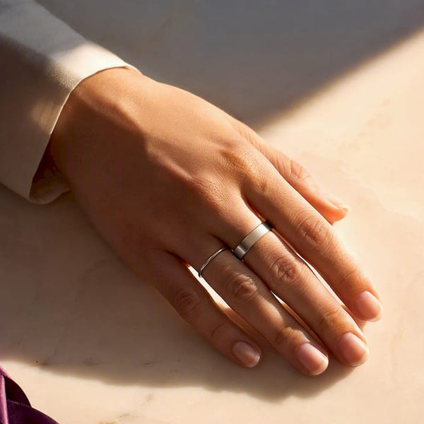 Cropped fingers showing contrasting ring widths