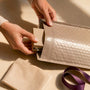 Hands preparing jewelry exchange package