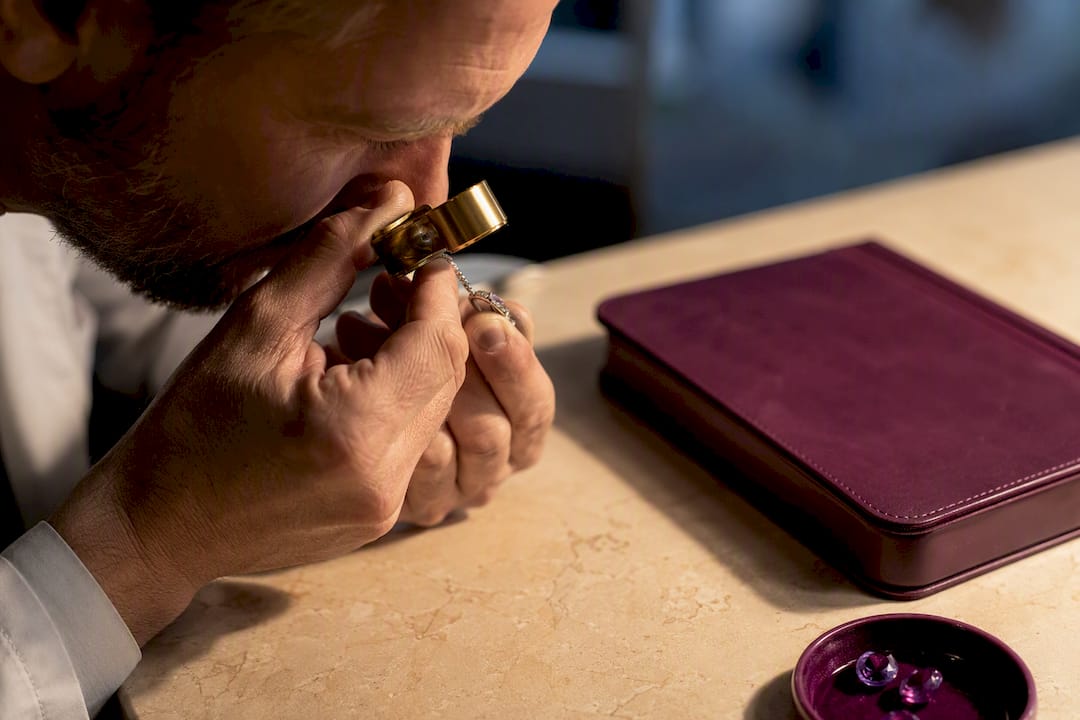 Gemologist inspecting jewelry for appraisal
