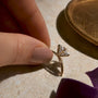 Cropped moissanite ring setting in dramatic light