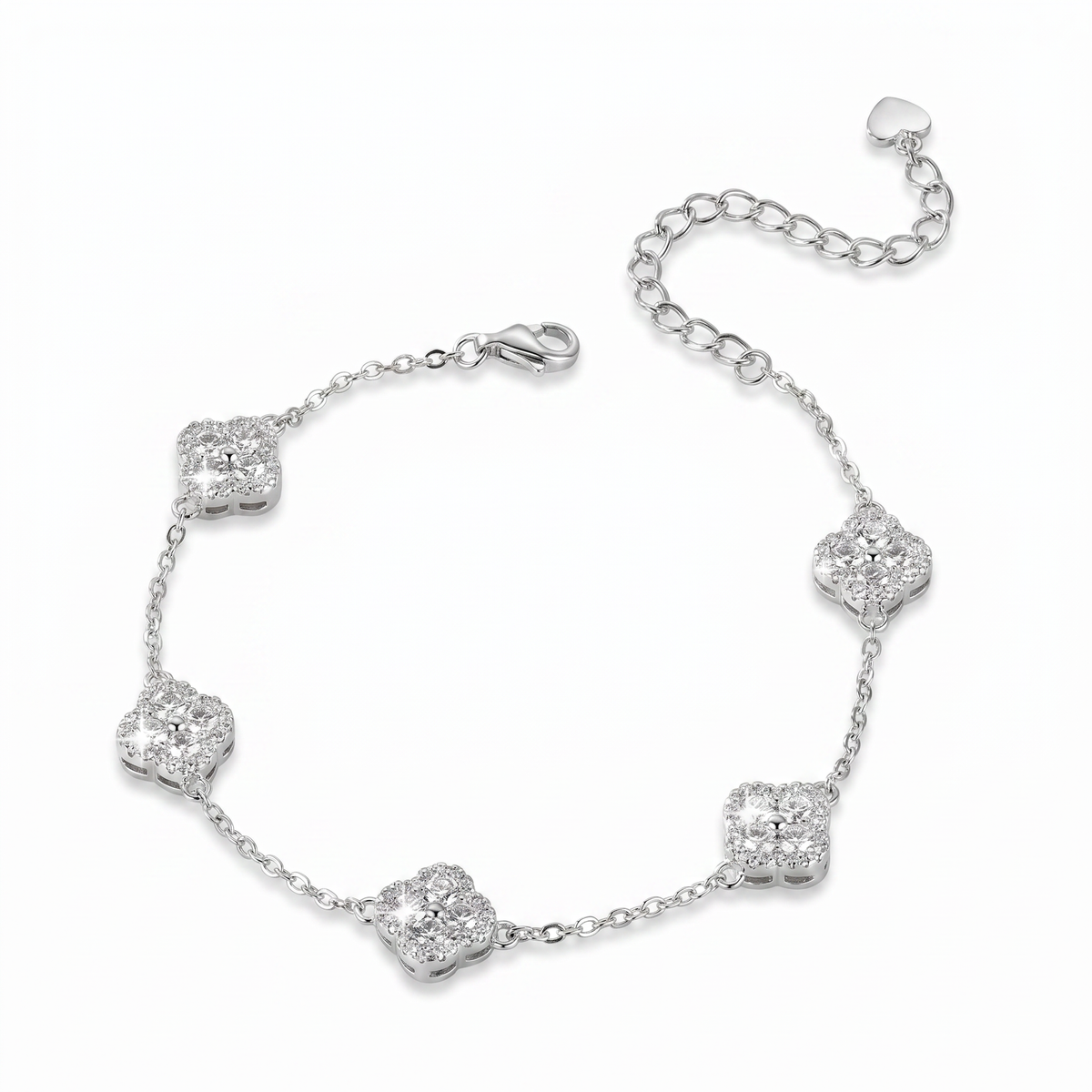 A silver chain bracelet featuring five pavé-set clear stones arranged in a floral clover pattern, with a lobster clasp and an adjustable extender chain with a heart-shaped tag, shown on a plain white background.